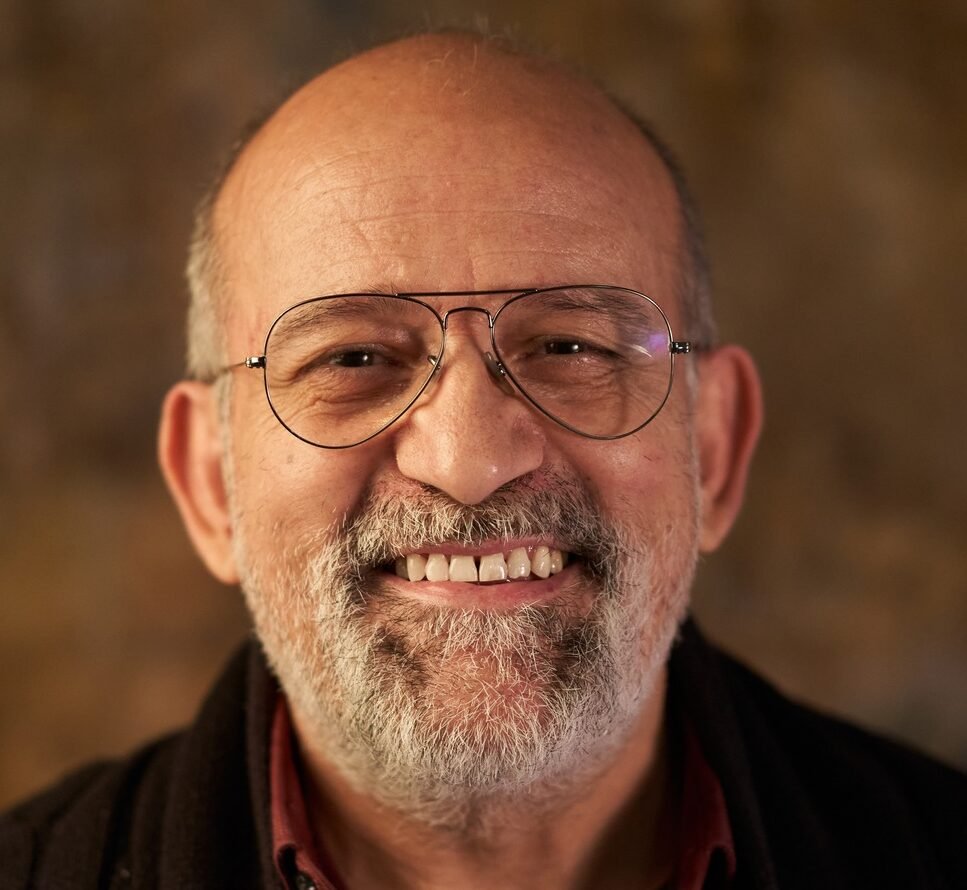 Portrait of a middle-aged Caucasian smiling man looking at camera. Look of an older person